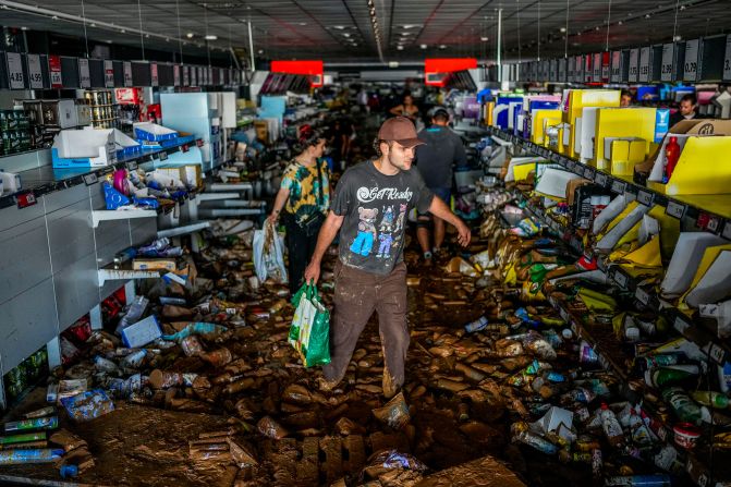 People pick up goods in a Valencia supermarket on Thursday.