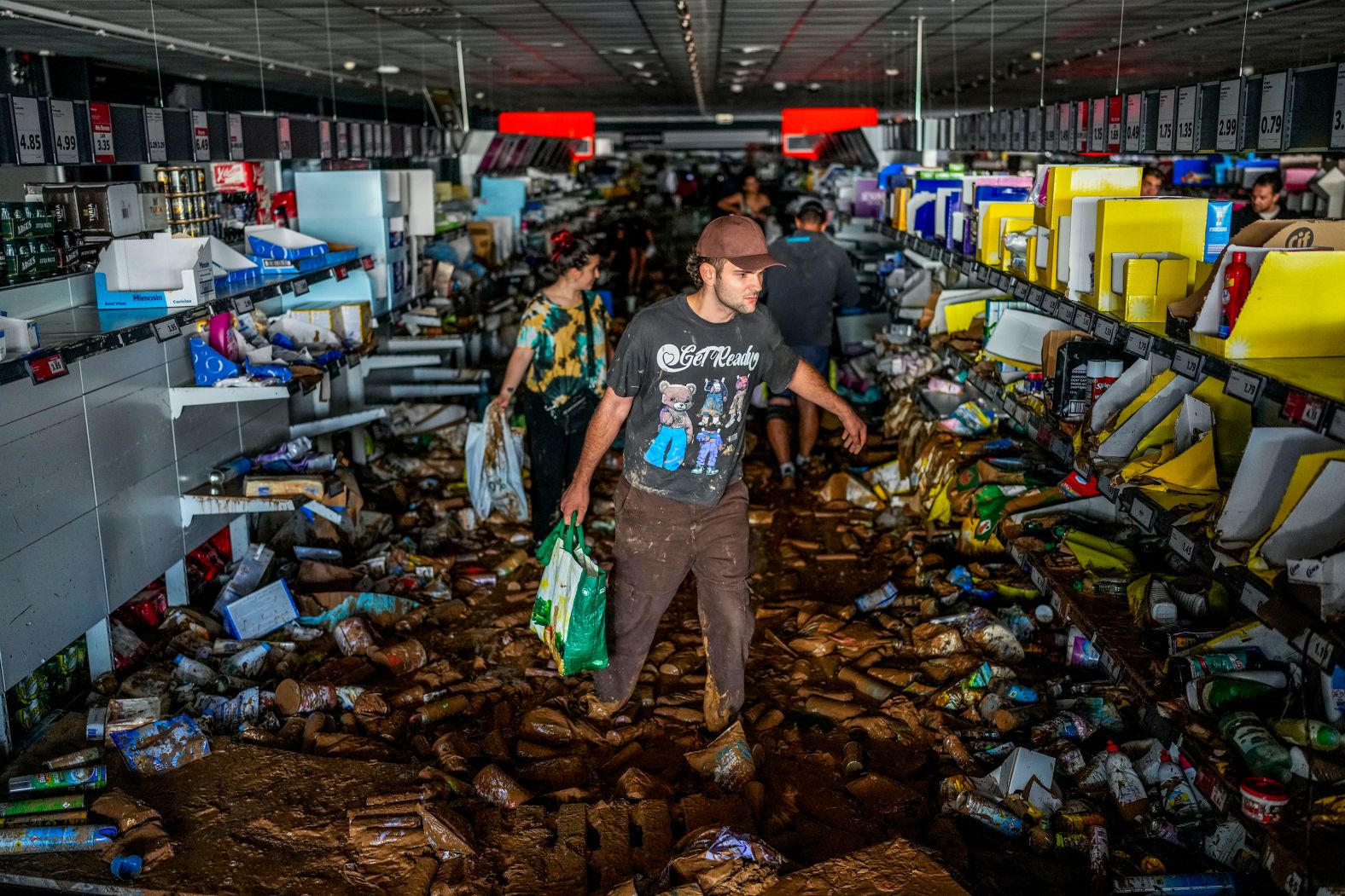 People pick up goods in a Valencia supermarket on Thursday.