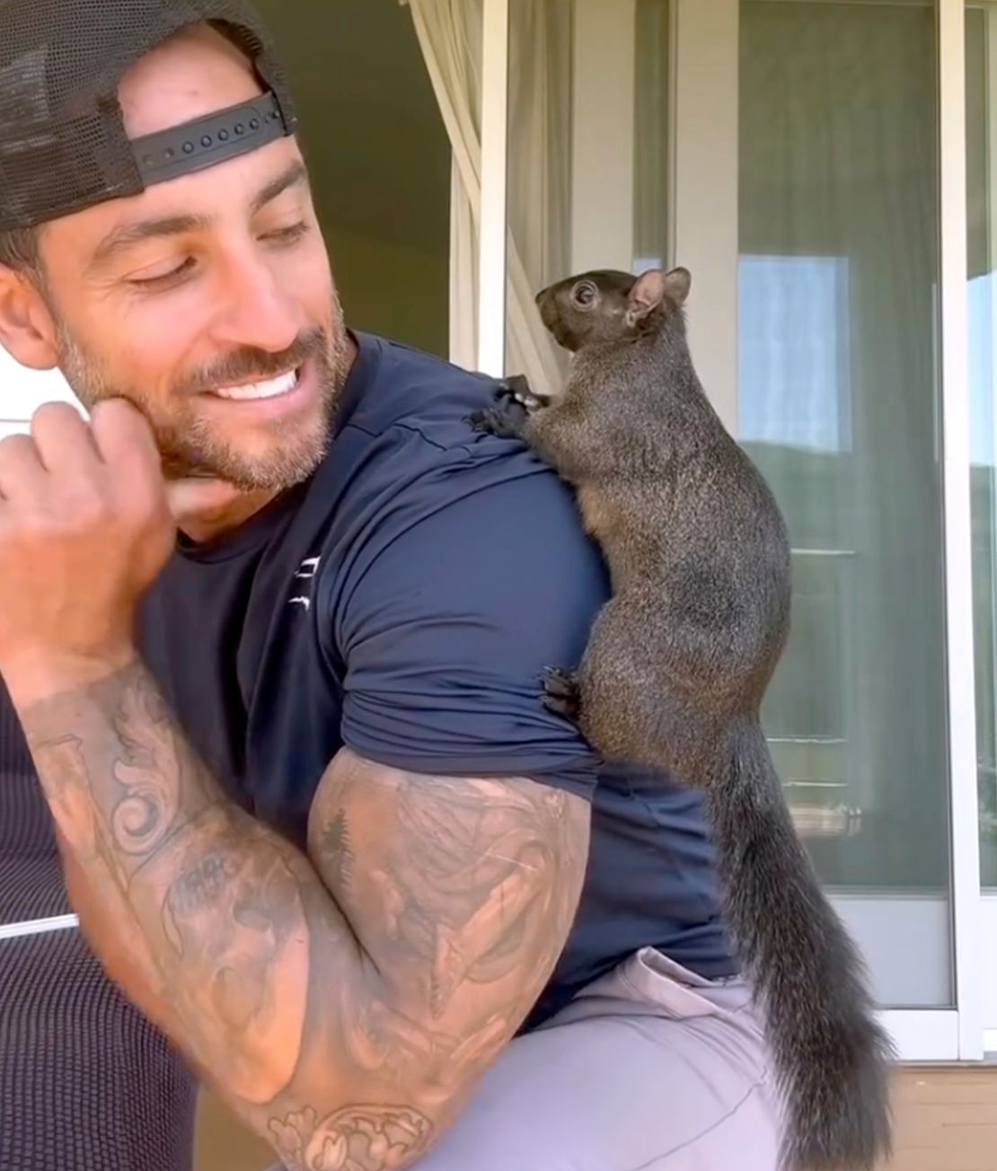 Mark Longo with his pet squirrel, Peanut.