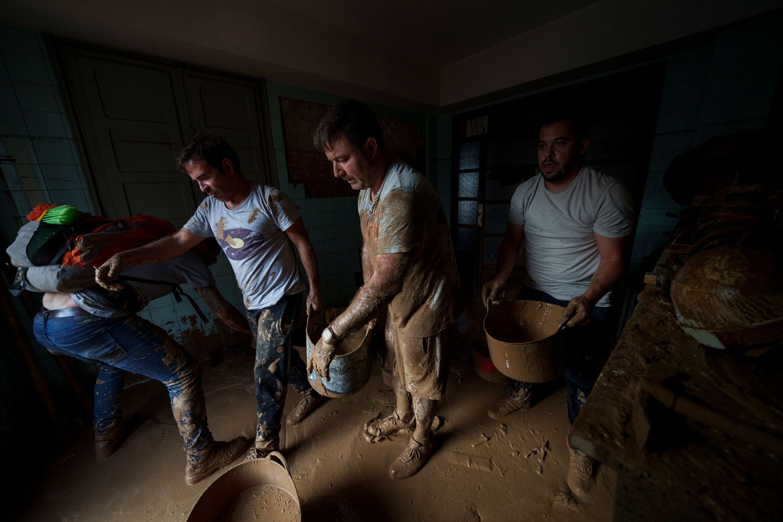 People remove mud from a house in Sedavi on Friday.