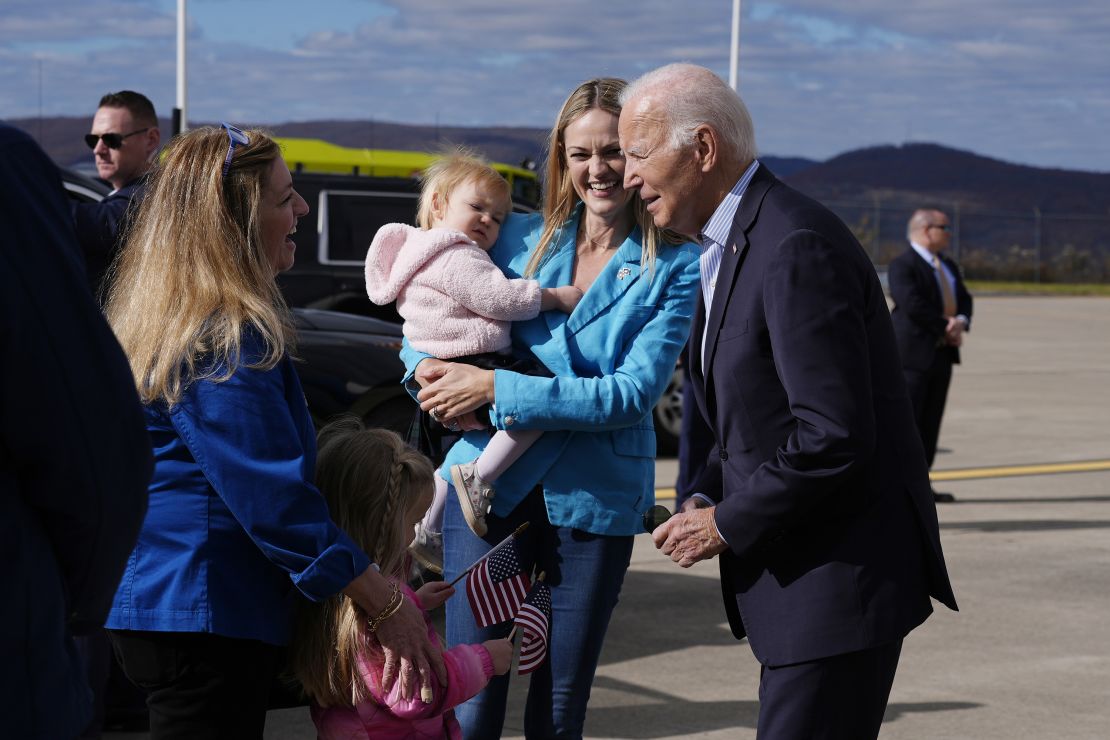 Biden is greeted on the tarmac by Scranton Mayor Paige Cognetti, second from right, holding her daughter Brooke Anne and Cognetti's mother Lynda Gebhardt on Nov. 2, 2024, at Wilkes-Barre Scranton International Airport in Pennsylvania.