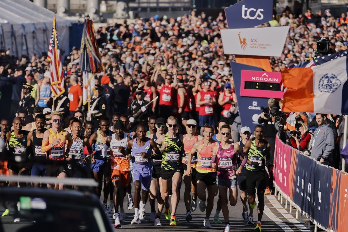 The elite men's runners set off from the starting line.