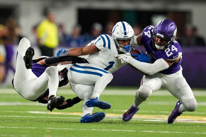 Indianapolis Colts wide receiver Josh Downs is tackled by Minnesota Vikings cornerback Byron Murphy Jr., left, and safety Camryn Bynum during the Vikings' 21-13 victory in Minneapolis on November 3.