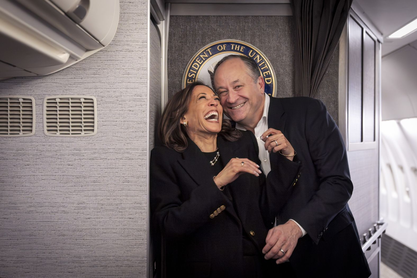 Harris shares a laugh with second gentleman Doug Emhoff after reuniting aboard Air Force Two on November 4. They had just taken off from Pittsburgh for her final campaign rally in Philadelphia.