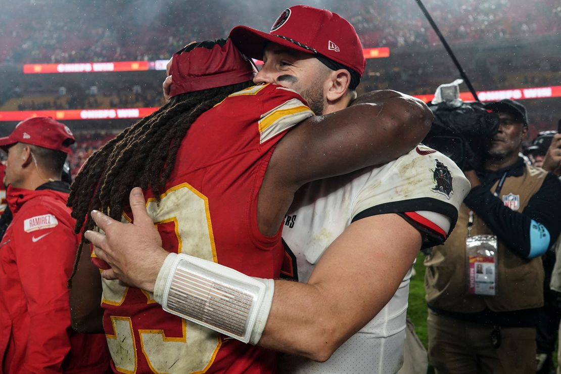 Buccaneers quarterback Baker Mayfield and Chiefs running back Kareem Hunt hug after a hard-fought game.