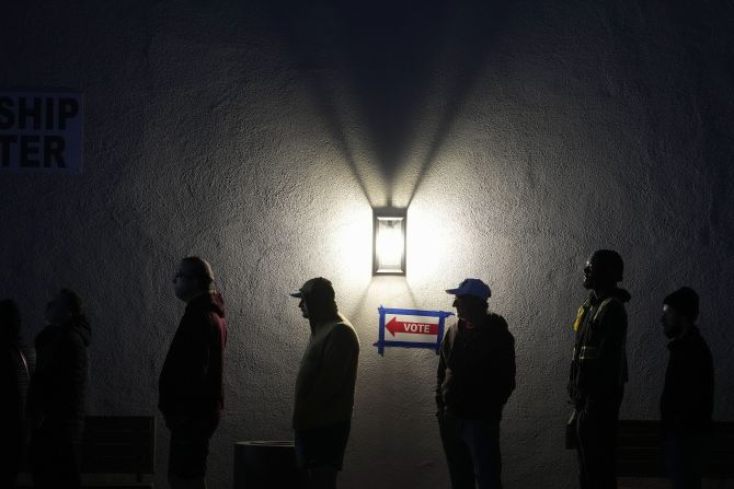 Voters stand in line outside a polling place in Phoenix on Tuesday.