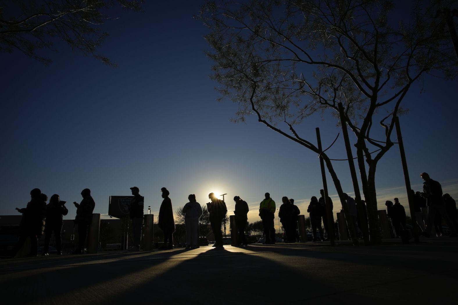 People line up to vote outside Allegiant Stadium, home of the Las Vegas Raiders, on Tuesday.