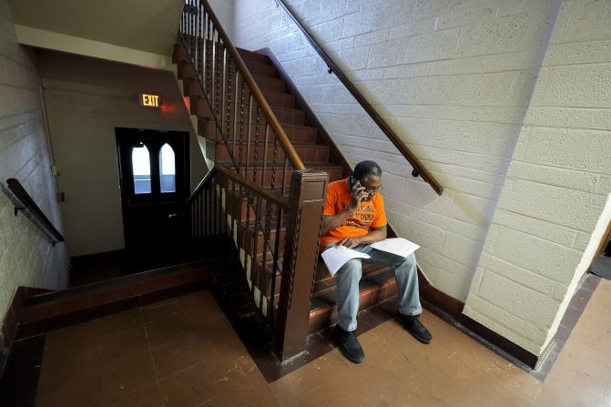 Ken Brandon, a deacon at Hartford Memorial Baptist Church in Detroit, makes phone calls Tuesday to get out the vote and offer rides to a polling place.