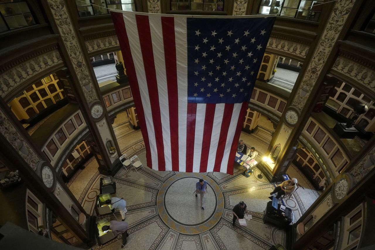 A large flag hangs from the ceiling as people vote at the San Francisco Columbarium & Funeral Home in San Francisco on Election Day.