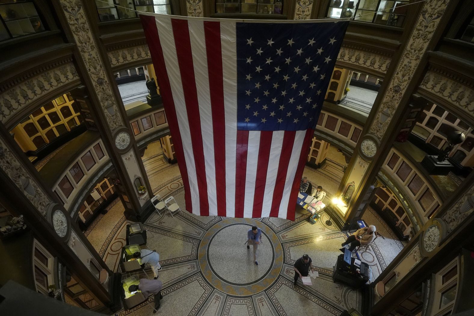 A large American flag hangs from the ceiling as people vote at the San Francisco Columbarium & Funeral Home on Tuesday.