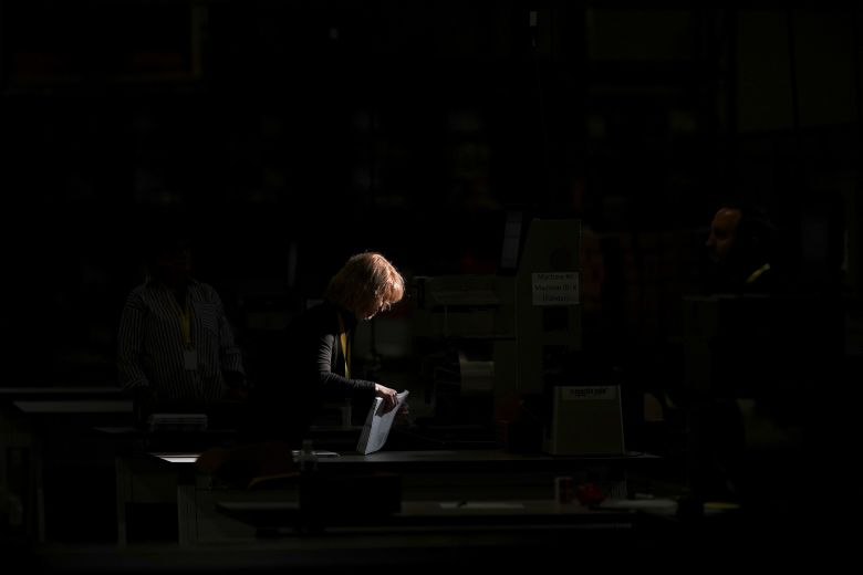 An election worker processes mail-in ballots for the 2024 election in Philadelphia on November 5, 2024.