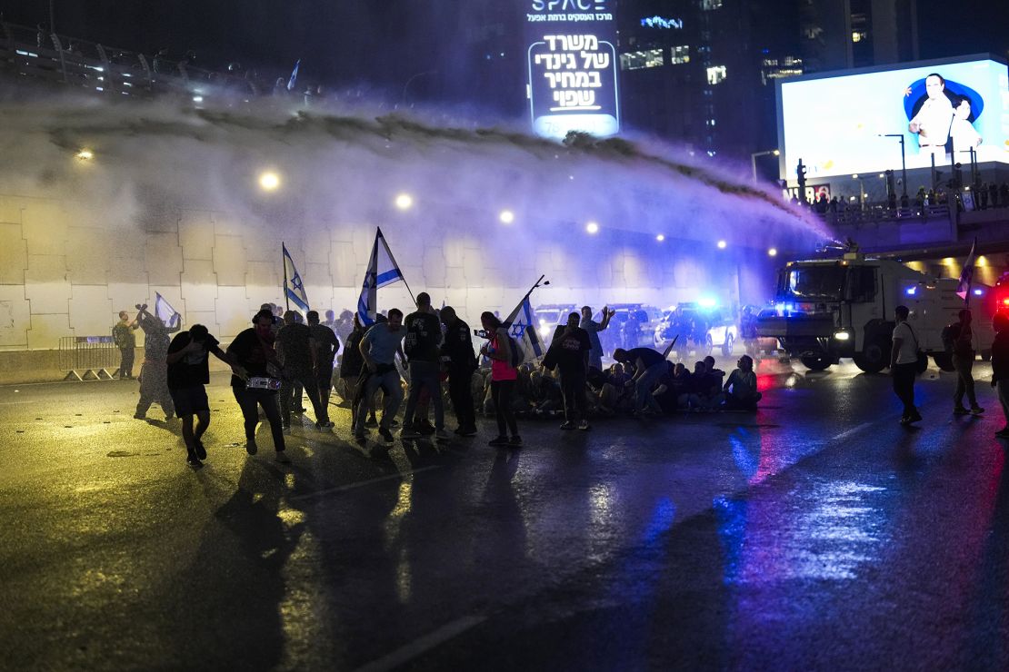 Police use water cannons to clear protesters.