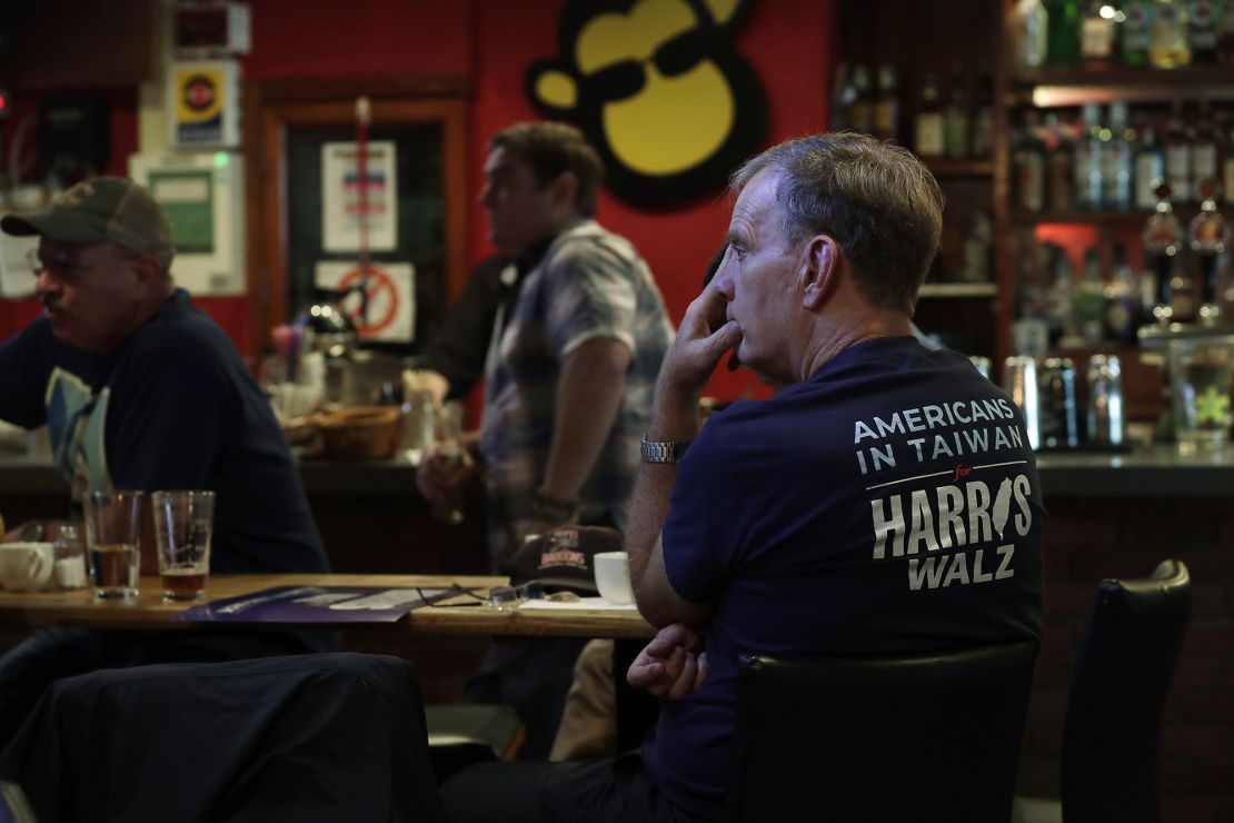 A supporter of Kamala Harris watches televised reports of the US presidential election during a watch party in Taipei, Taiwan, on November 6, 2024.