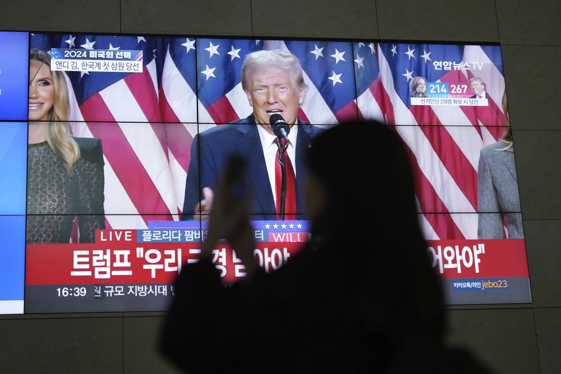 A screens shows live footage of Donald Trump speaking during a news program in Seoul, South Korea, on November 6, 2024.