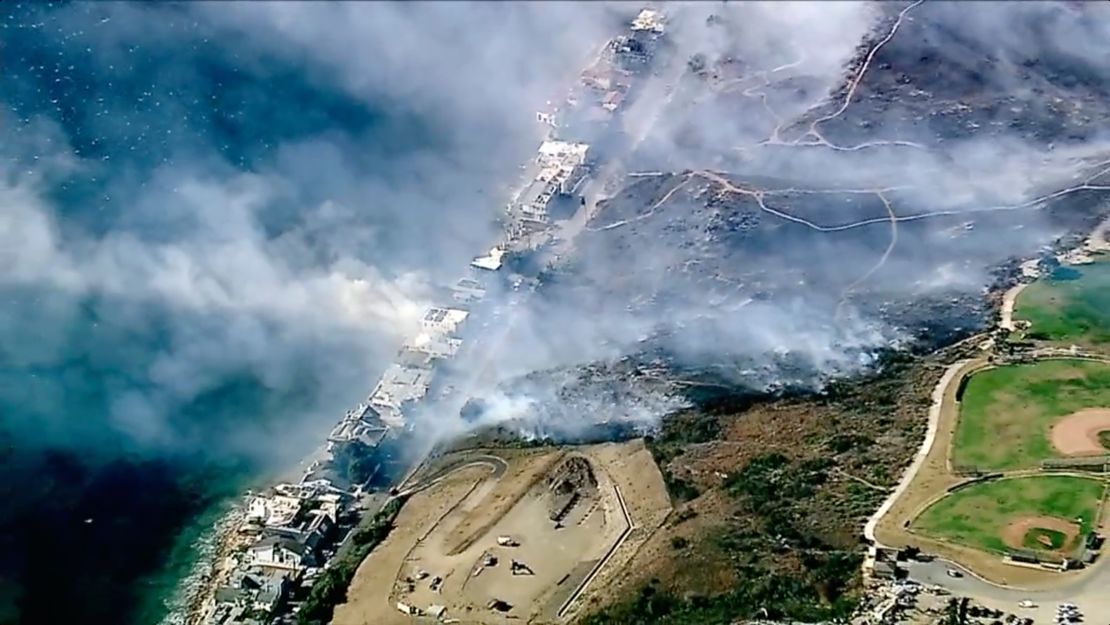 Los Angeles County Fire Department crews scrambled to contain a blaze fed by erratic wind gusts that pushed flames through dry brush near Broad Beach along Pacific Coast Highway in Malibu on Wednesday.