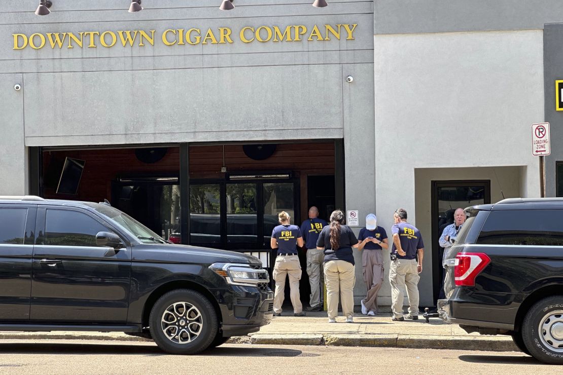 Federal authorities, Wednesday, May 22, 2024, in Jackson, Miss. gathered downtown outside a business owned by Hinds County District Attorney Jody Owens.