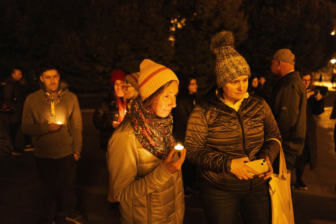 Friends hold candles while remembering Mackenzie Michalski, an 31-year-old American tourist who was murdered while on vacation, during a candlelight vigil in Budapest, Hungary, on Nov. 9, 2024.