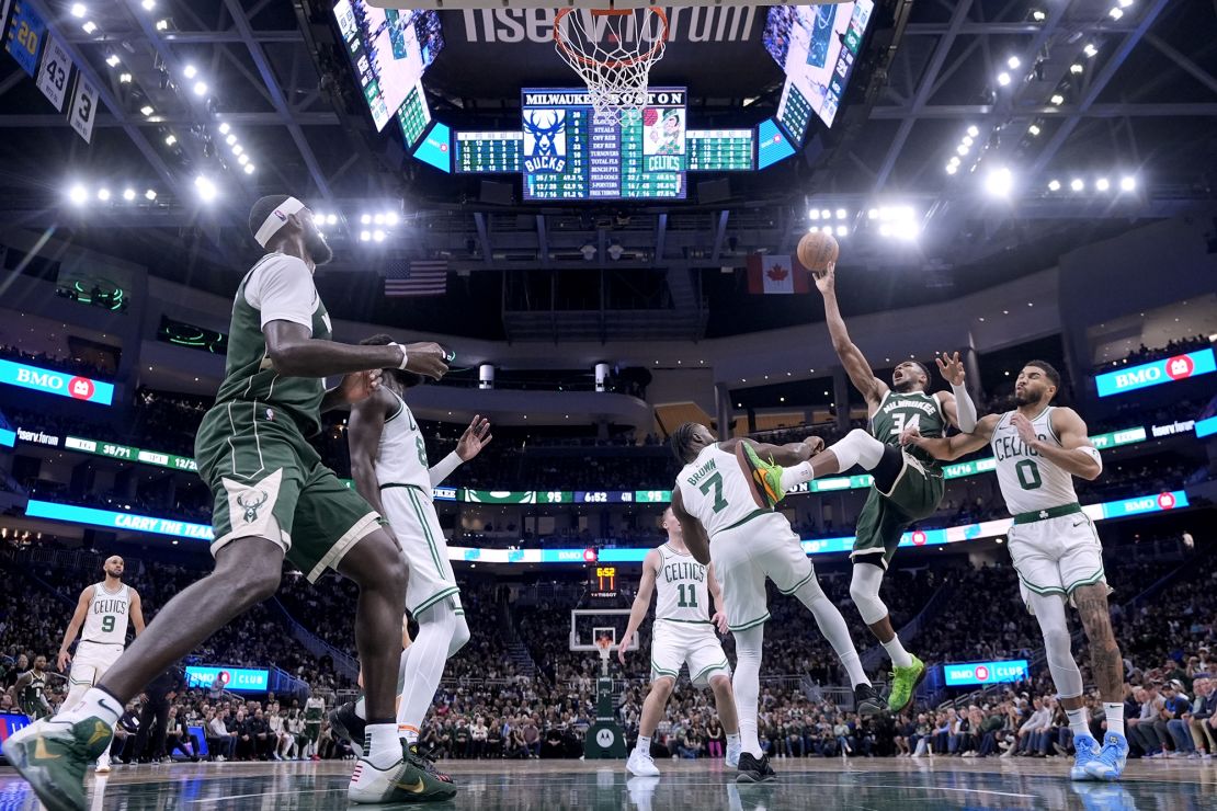 The Milwaukee Bucks' Giannis Antetokounmpo is fouled by the Boston Celtics' Jaylen Brown during the second half.