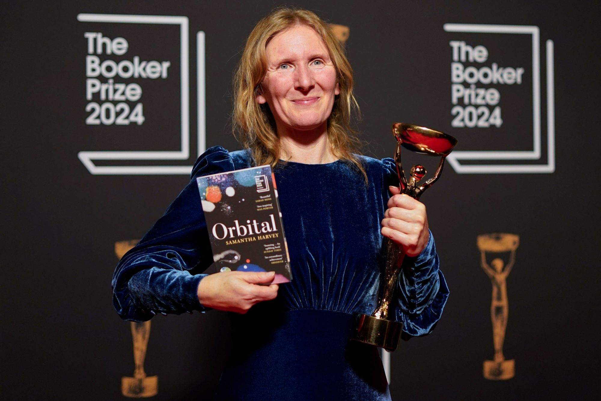 Samantha Harvey poses with her book "Orbital" after winning the 2024 Booker Prize in London.