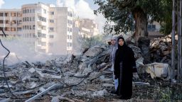 two women stand next to the destruction in the city centre of tyre, following an israeli airstrike in the southern lebanese port city, killing at least seven, three of whom were deaf and mute over the weekend. explosion continues in the south of lebanon as hezbollah and israel's conflict has not see an end. (photo by ashley chan / sopa images/sipa usa)(sipa via ap images)