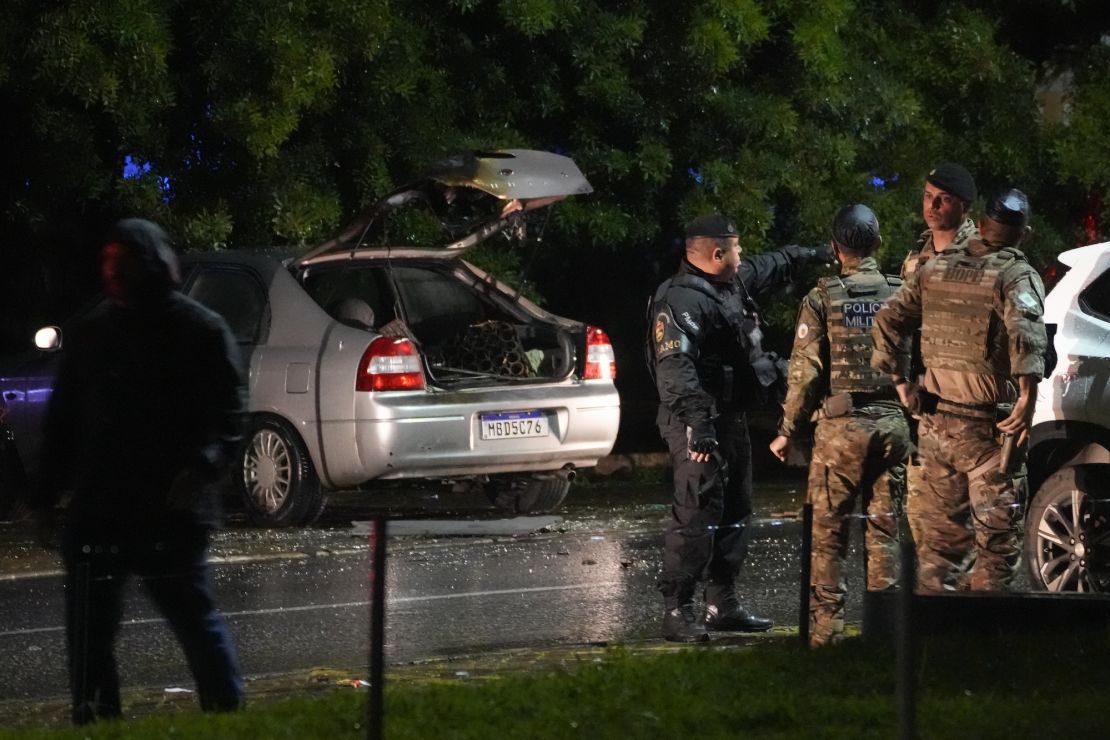 Police inspect a vehicle outside the Supreme Court in Brasília, Brazil, after an explosion on November 13.