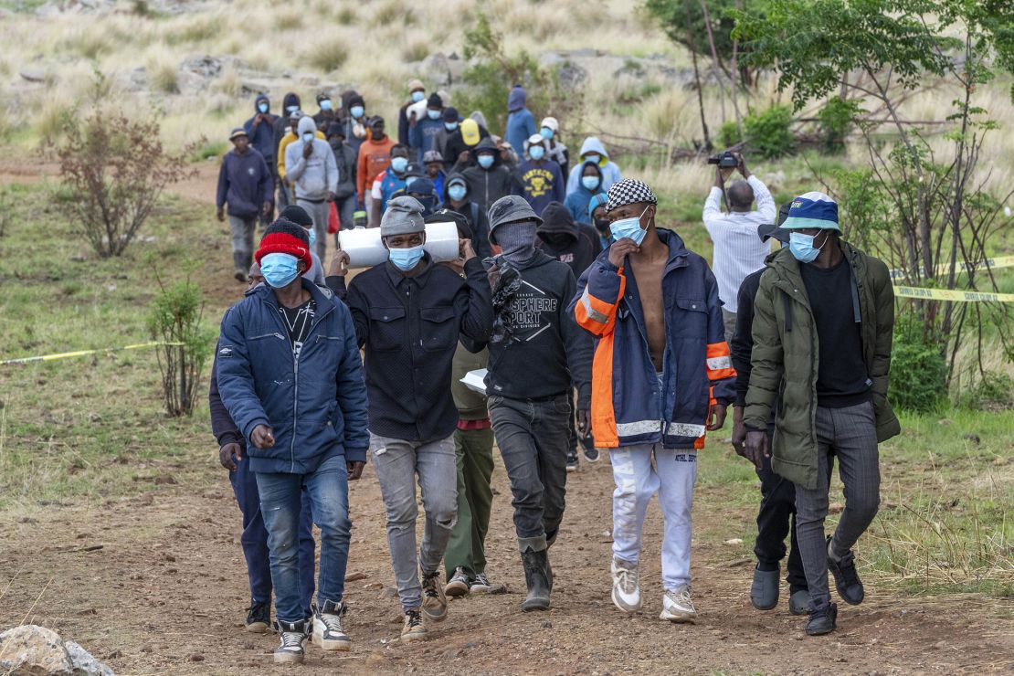 Volunteer rescue workers and community members leave the area near a closed mine where illegal miners are inside in Stilfontein, South Africa, Thursday, Nov. 14, 2024.