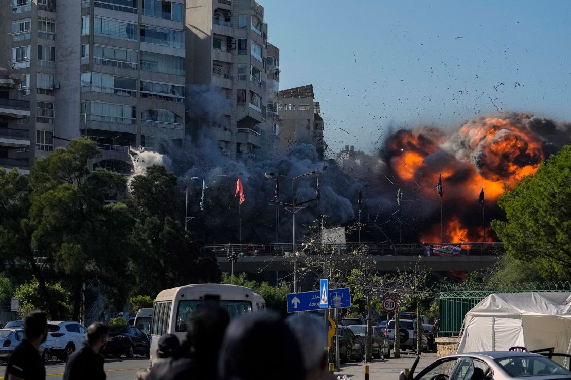 Thick smoke and flames erupt from the building after it is struck.