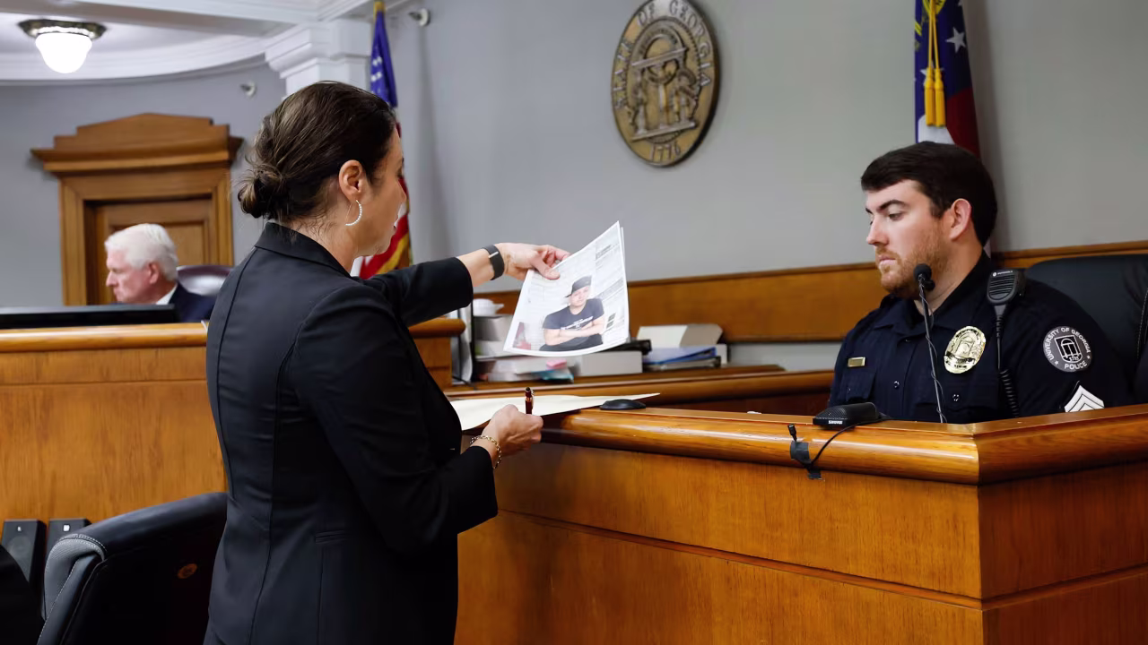 Prosecutor Sheila Ross shows a piece of evidence to University of Georgia Sgt. Joshua Epps during the trial of Jose Ibarra at Athens-Clarke County Superior Court on Monday.