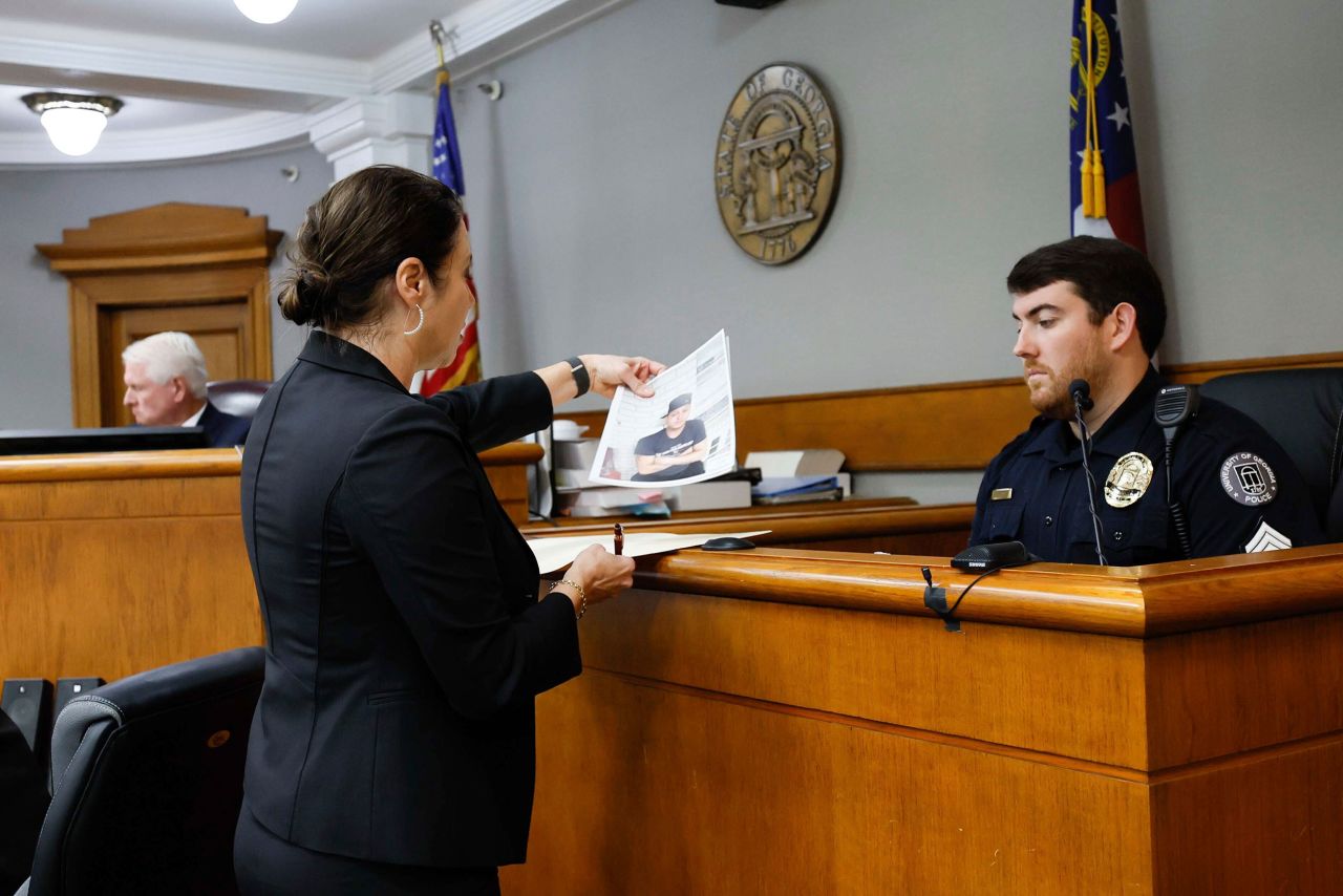 Prosecutor Sheila Ross shows a piece of evidence to University of Georgia Sgt. Joshua Epps during the trial of Jose Ibarra at Athens-Clarke County Superior Court on Monday.