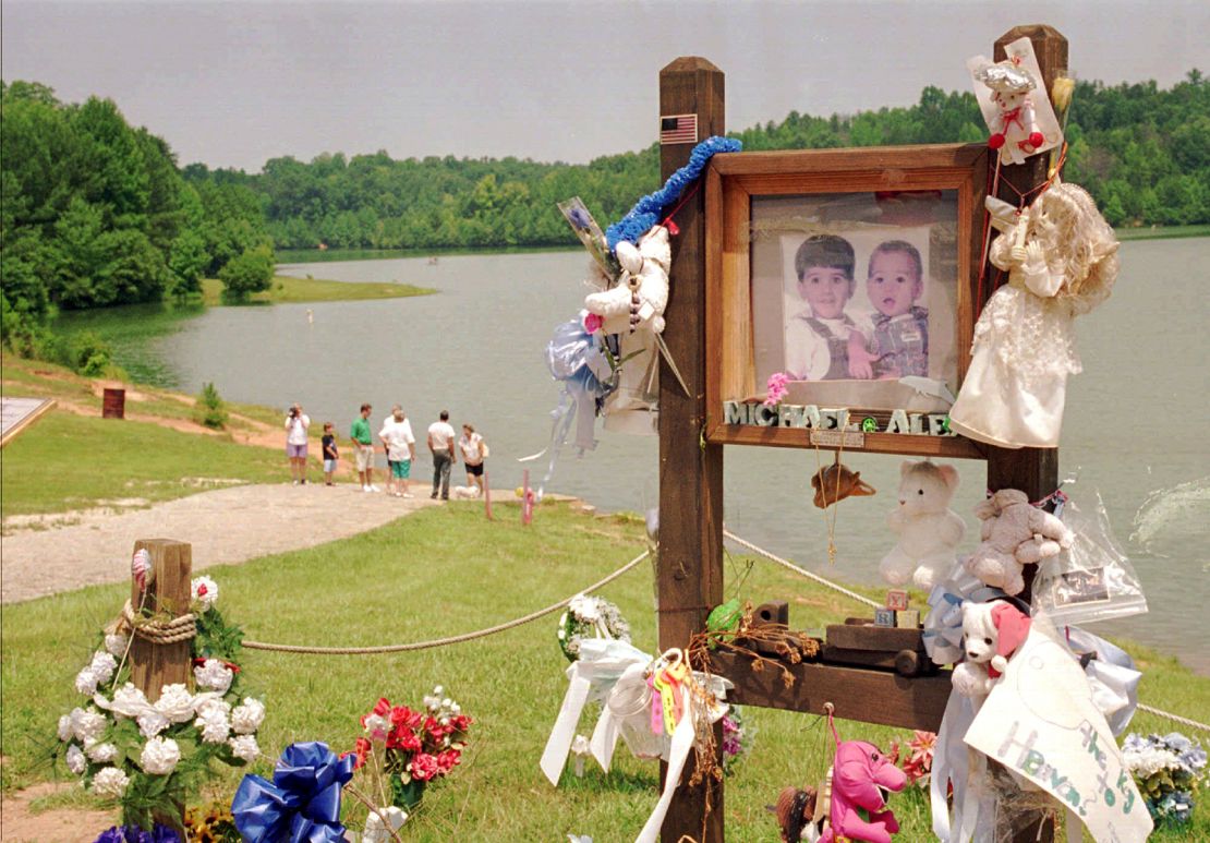 Visitors on July 9, 1995, walk down the ramp where Alex and Michael Smith were drowned in a car in 1994 in Union, South Carolina.