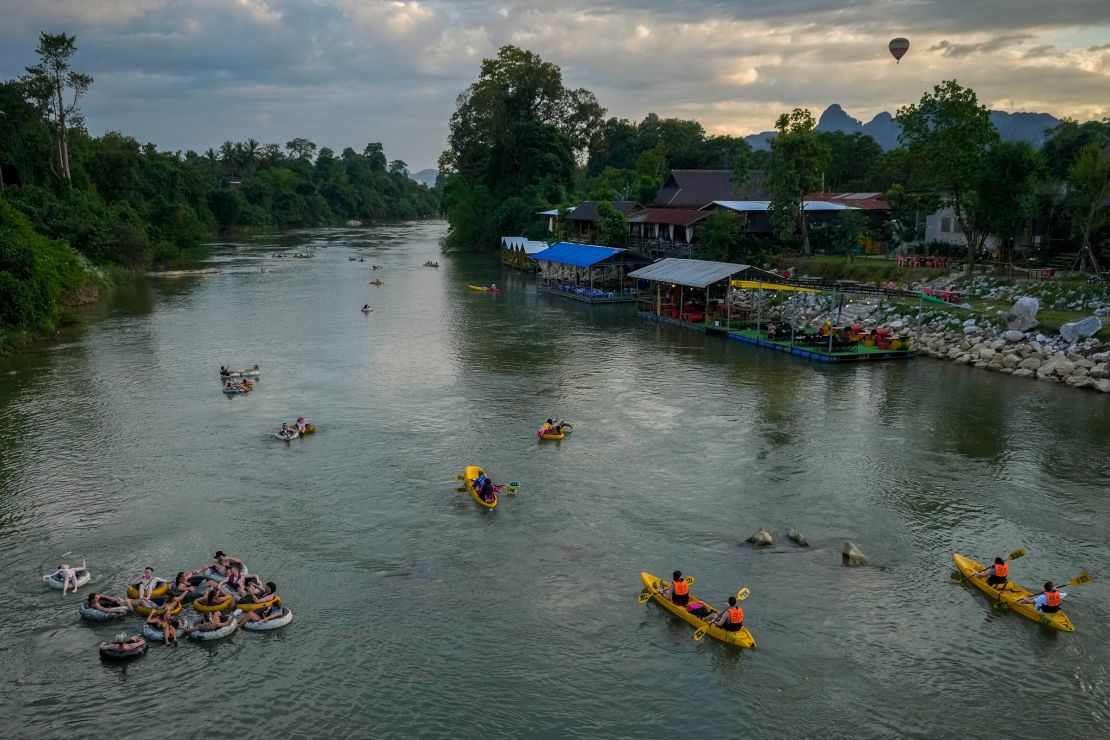 Foreign tourists kayaking and tubing on the Song River in Vang Vieng, Laos, on November 19.