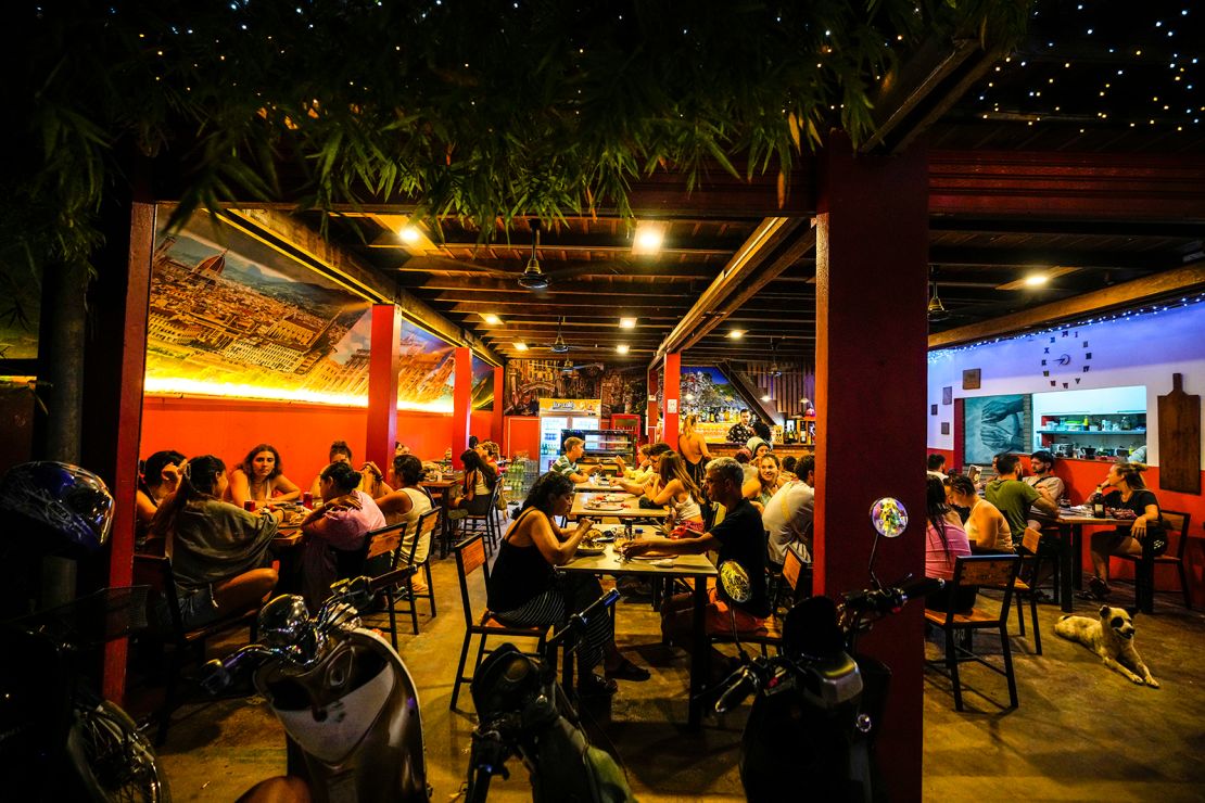 Tourists have dinner at a hostel in Vang Vieng, Laos, on November 19, 2024.