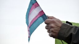 FILE - A person holds a transgender flag to show their support for the transgender community during the sixth annual Transgender Day of Remembrance at Maryville College, Nov. 20, 2016, in Maryville, Tenn. (Brianna Bivens/The Daily Times via AP, File)