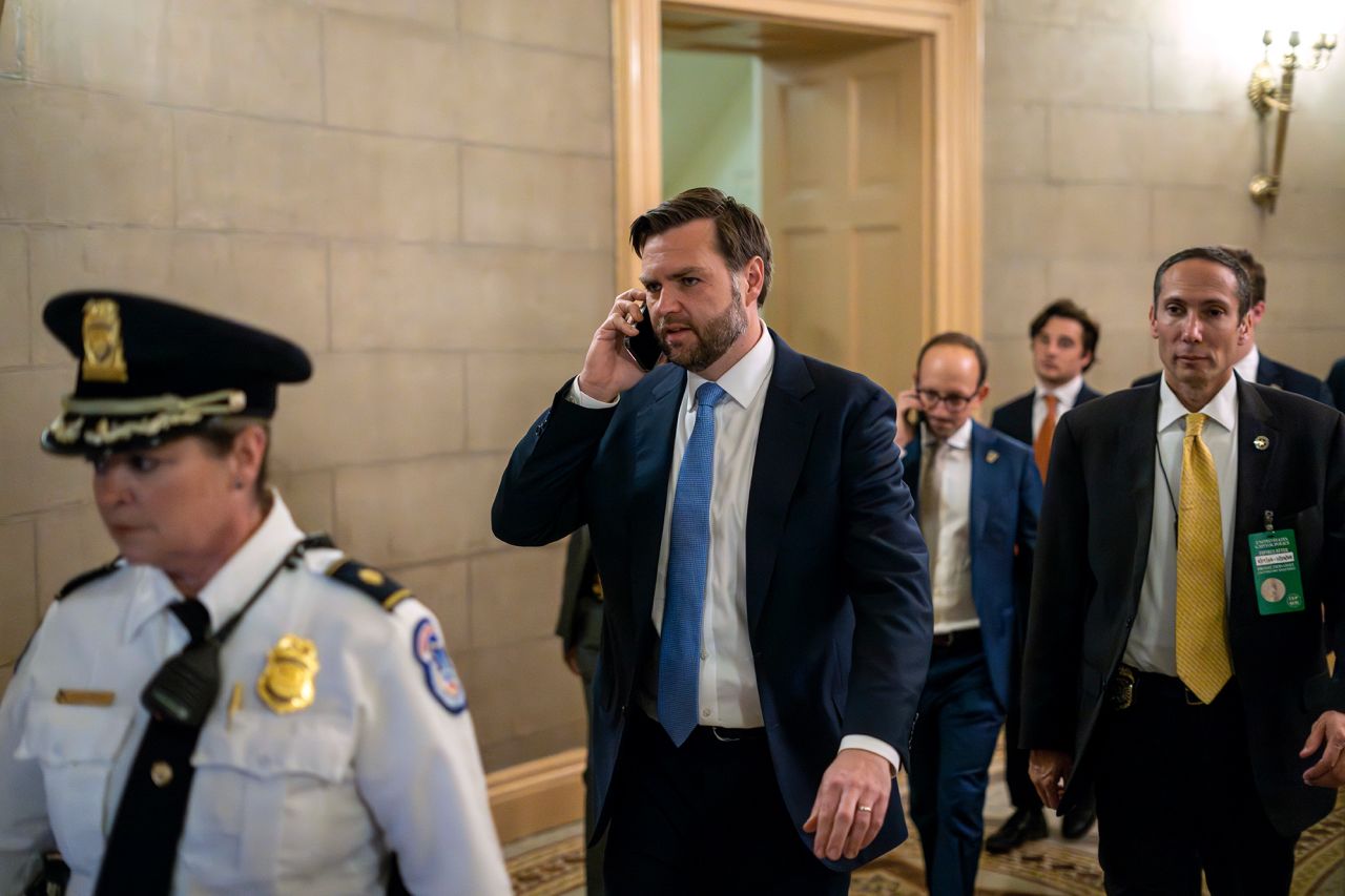 Vice President-elect JD Vance speaks on his cellphone as he arrives for private meetings at the Capitol in Washington, on Wednesday.