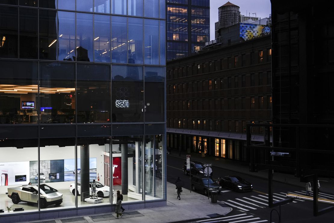 People walk past a Tesla store in the Meatpacking District of Manhattan, Friday, November 22, 2024, in New York.