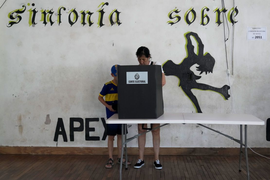 A voter marks the ballot in the presidential run-off election in Montevideo, Uruguay, Sunday, Nov. 24, 2024.