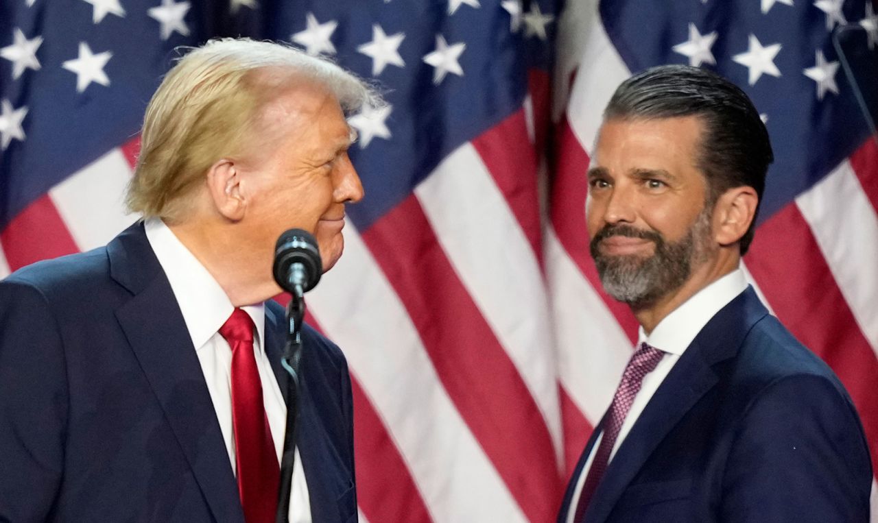 President-elect Donald Trump, left, looks at his son Donald Trump Jr. at an election night watch party, November 6, in West Palm Beach, Florida. (