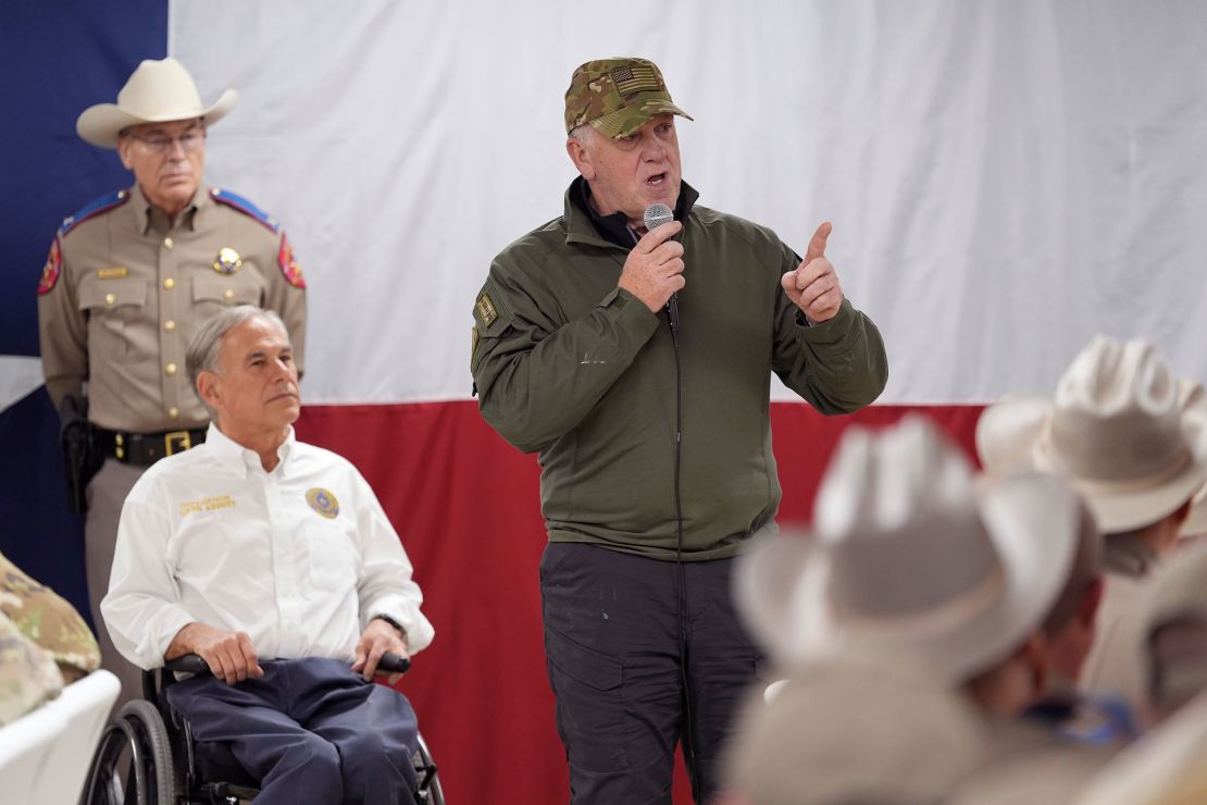 Incoming Border Czar Tom Homan, right, speaks before helping to serve meals to state troopers and National Guard troops on November 26 in Eagle Pass, Texas, along the US-Mexico border. At left is Texas Gov. Greg Abbott, who's made immigration enforcement a top priority of his administration.