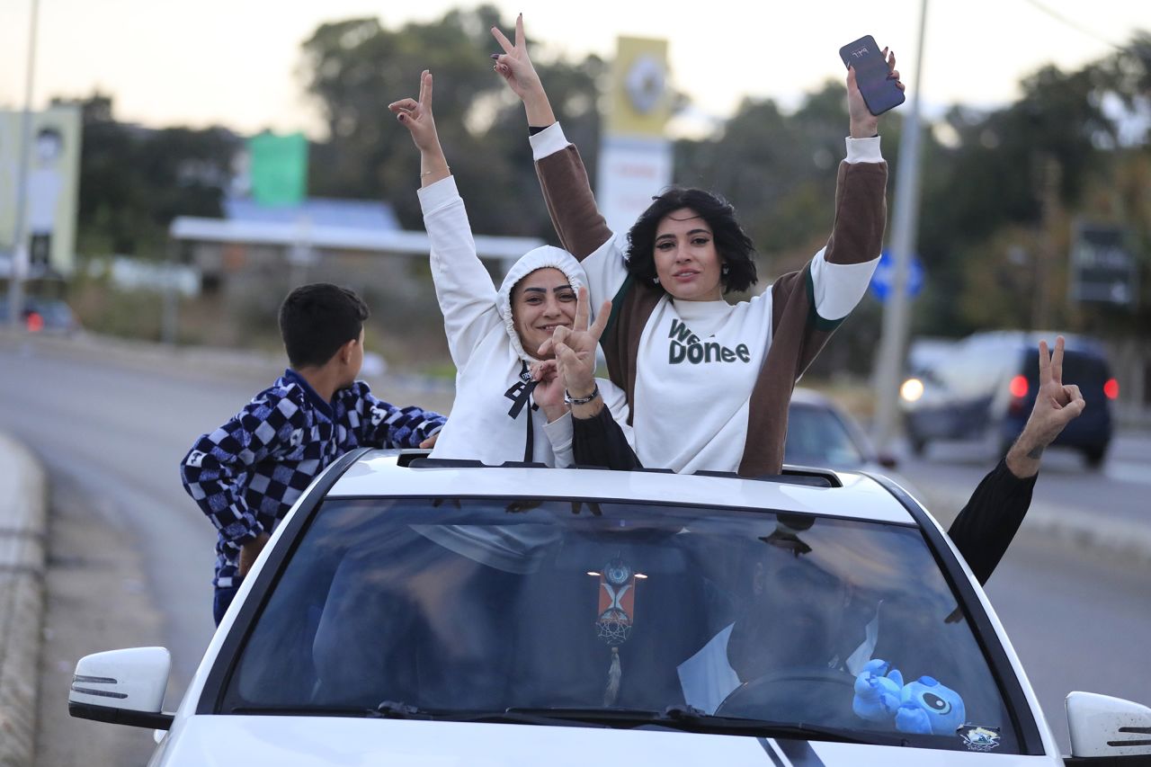 People celebrate after a ceasefire between Israel and Hezbollah went into effect in Sidon, Lebanon, on November 27.