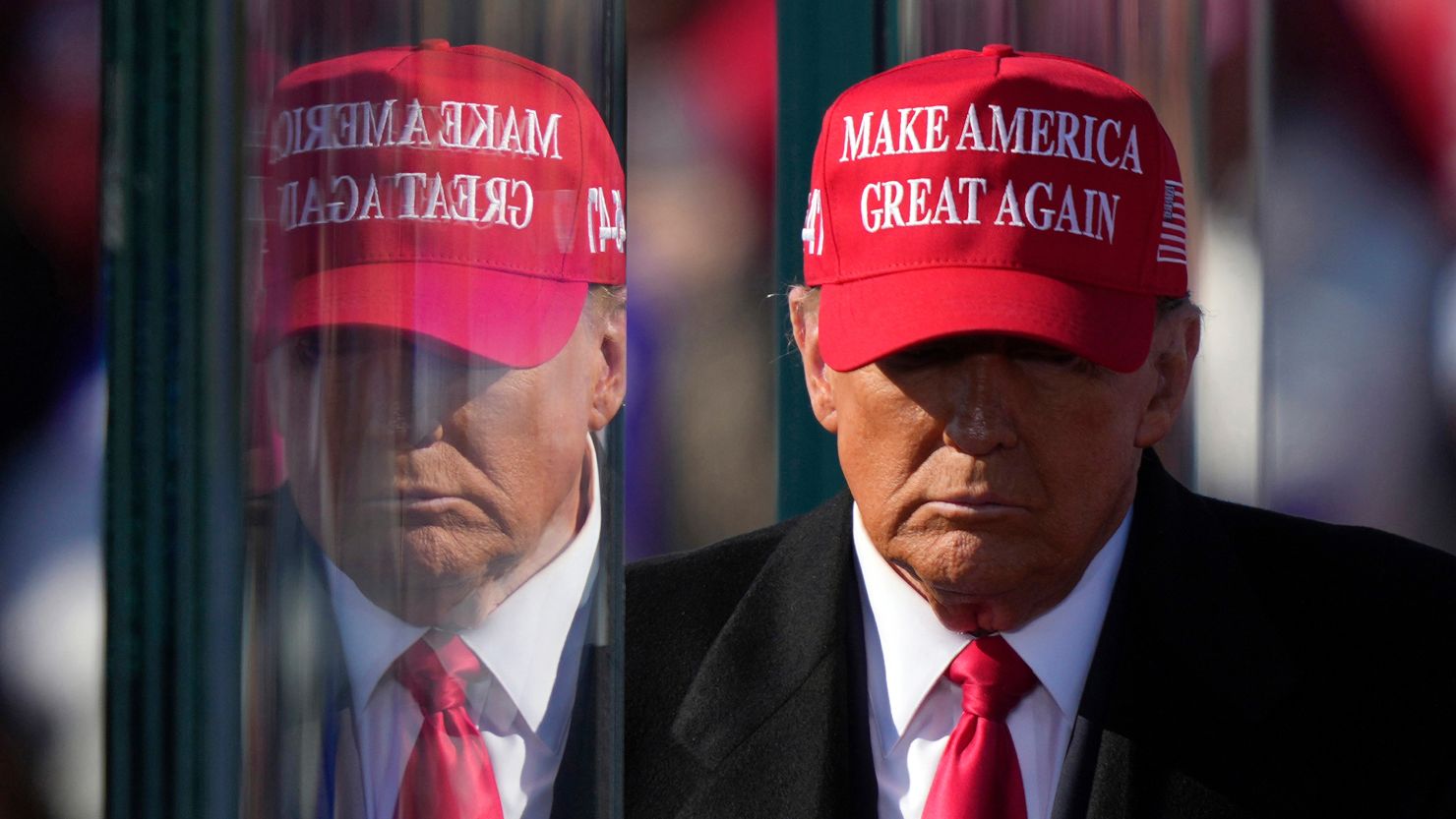 Donald Trump is reflected in bulletproof glass as he finishes speaking at a campaign rally in Lititz, Pennsylvania, on Sunday, November 3, 2024.