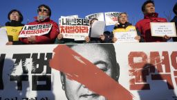 Protesters stage a rally to demand South Korean President Yoon Suk Yeol to step down in front of the National Assembly in Seoul, South Korea, Wednesday, December 4.