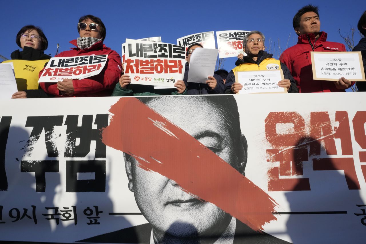 Protesters stage a rally to demand South Korean President Yoon Suk Yeol to step down in front of the National Assembly in Seoul, South Korea, Wednesday, December 4.