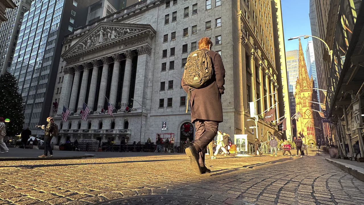 A person walks on Wall St. near the New York Stock Exchange in New York's Financial District on Wednesday, Dec. 4, 2024.