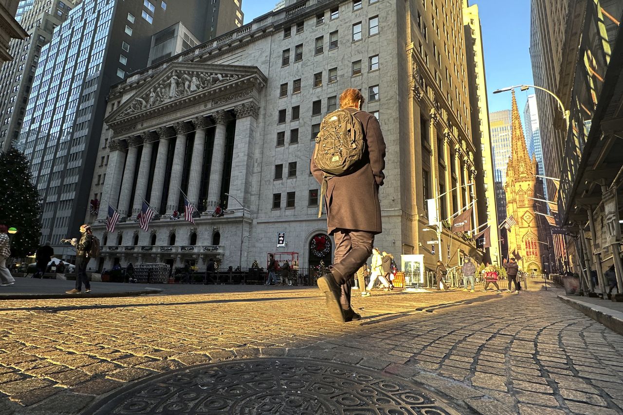 A person walks on Wall St. near the New York Stock Exchange in New York's Financial District on December 4.