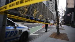 A New York police officer stands on 54th Street outside the Hilton Hotel in midtown Manhattan where Brian Thompson, the CEO of UnitedHealthcare, was fatally shot Wednesday, Dec. 4, 2024, in New York.