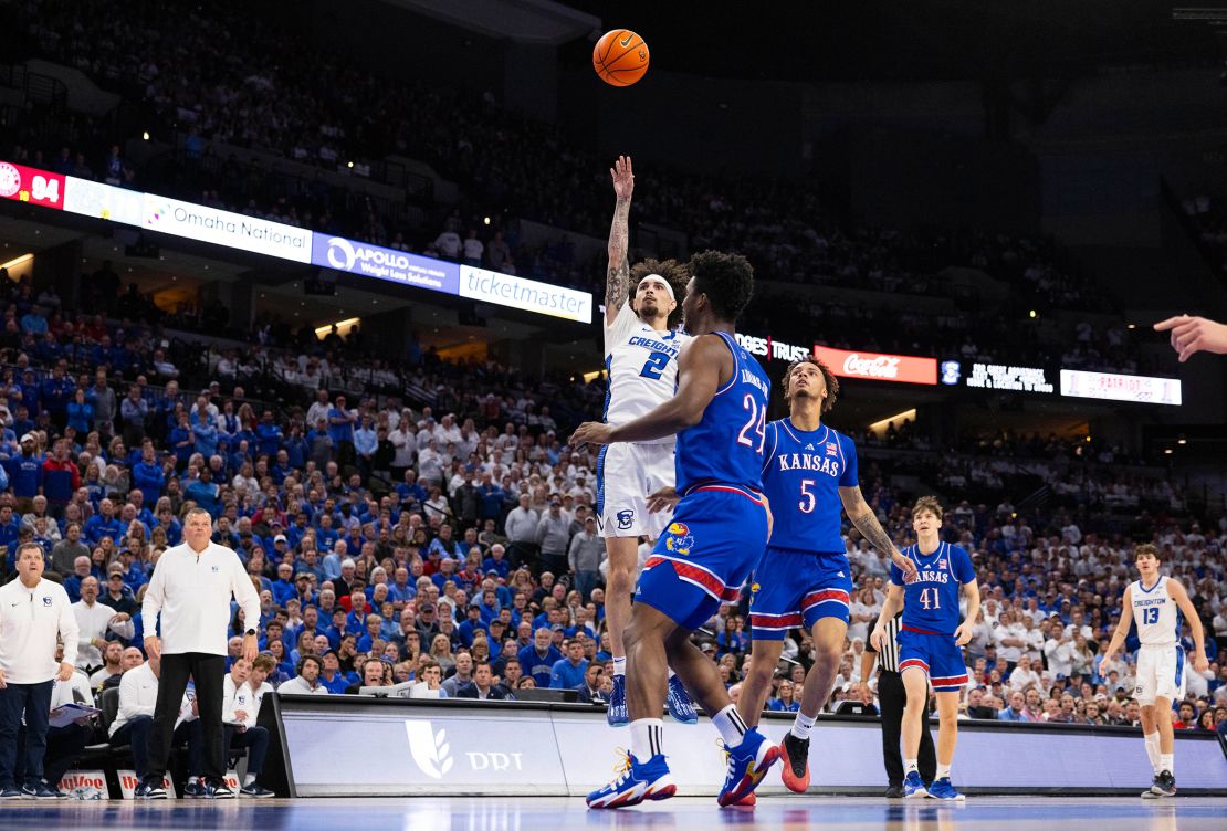 Creighton's Pop Isaacs shoots over Kansas' KJ Adams and Zeke Mayo at the CHI Health Center.