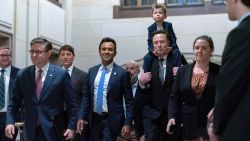 Speaker of the House Mike Johnson, R-La., from left, walks with Vivek Ramaswamy and Elon Musk, who is carrying his son X Æ A-Xii, as they arrive for a roundtable meeting to discuss President-elect Donald Trump's planned Department of Government Efficiency, on Capitol Hill in Washington, Thursday, Dec. 5, 2024. (AP Photo/Jose Luis Magana)