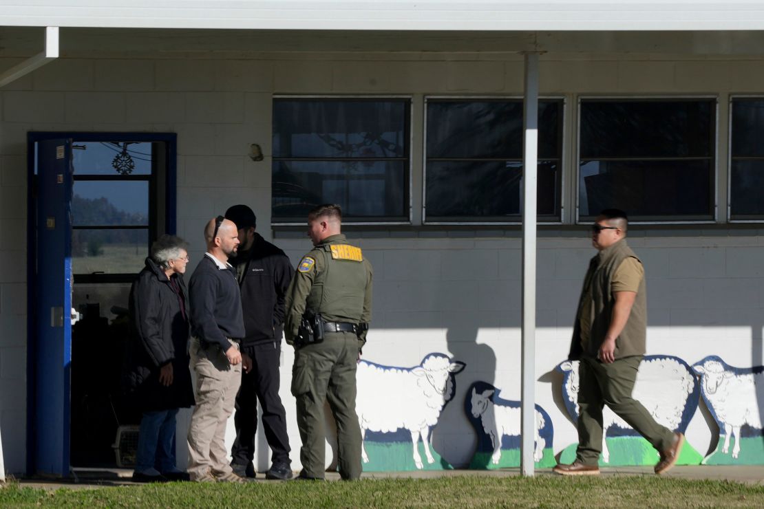 School officials and sheriff's deputies gather outside Feather River Adventist School after a shooting in Oroville, California.