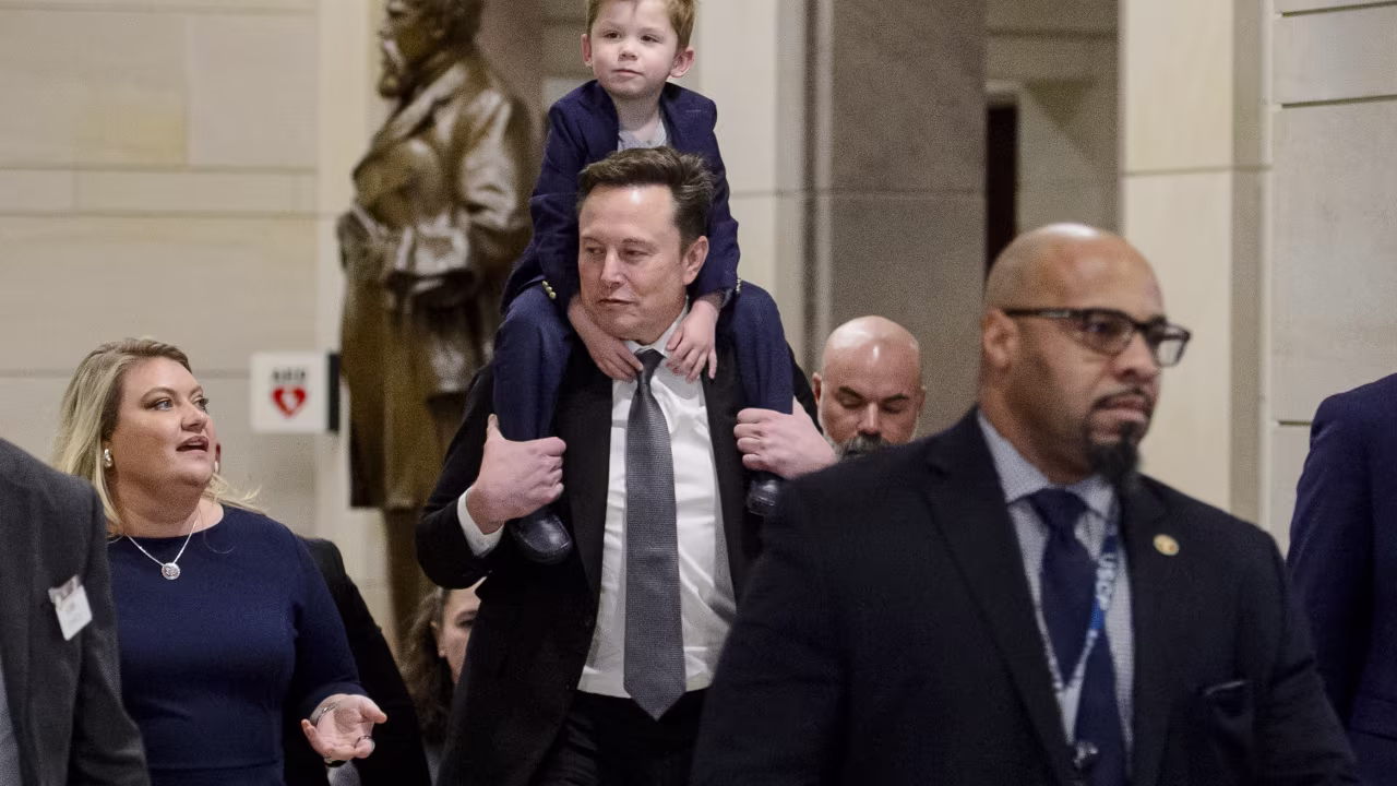 Elon Musk, President-elect Donald Trump's pick for the planned Department of Government Efficiency, carries his son X Æ A-Xii on his shoulders, following a meeting with members of Congress at the Capitol, on Thursday, December 5, in Washington, DC.