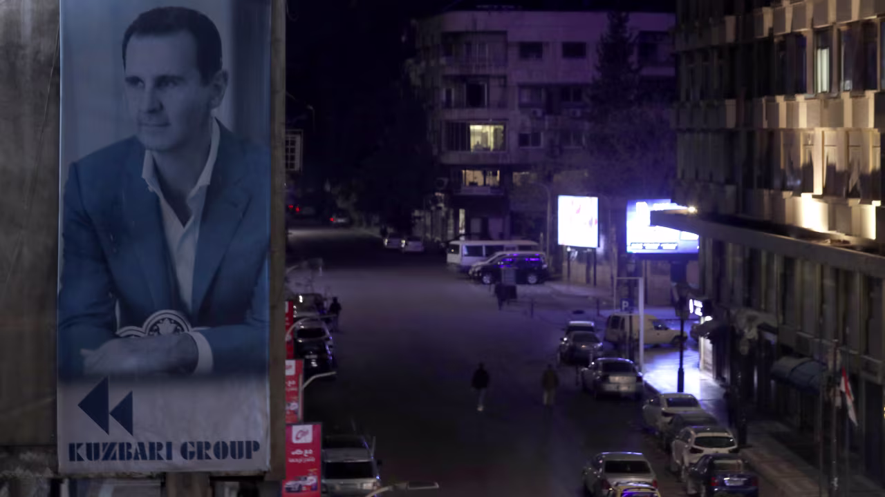 A portrait of Syrian President Bashar al-Assad is seen on a building in Damascus, Syria, on December 7.